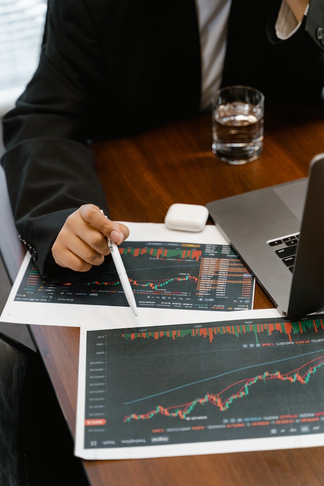 photo of man looking at figures